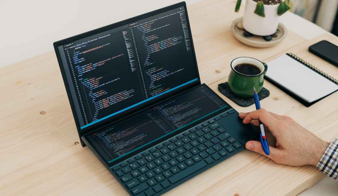 man coding on a laptop