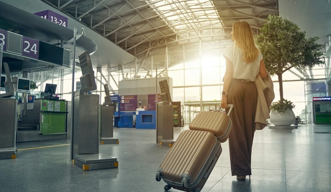 woman carrying her luggage at the airport
