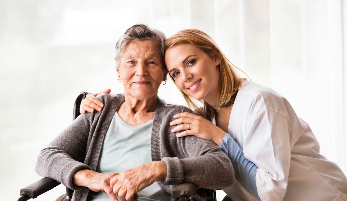 health visitor and a senior woman smiling
