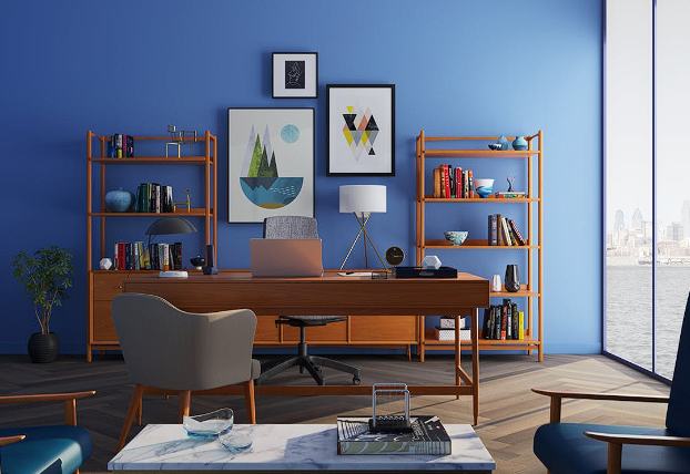 Modern home office with wooden desk, blue wall, and shelving