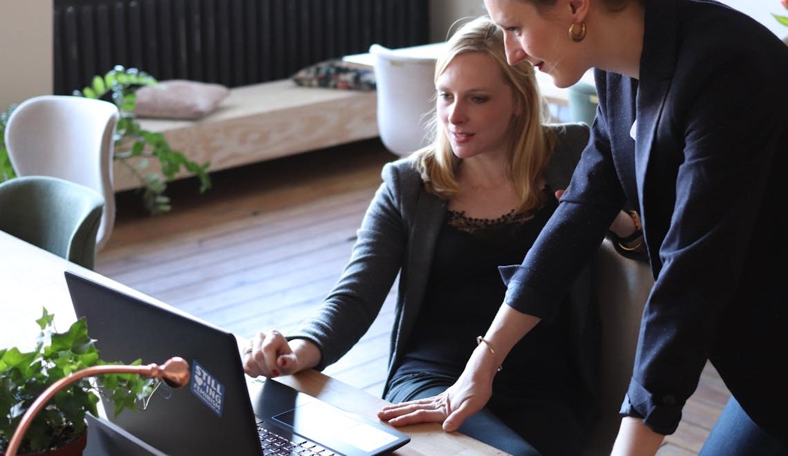 Two women using a laptop