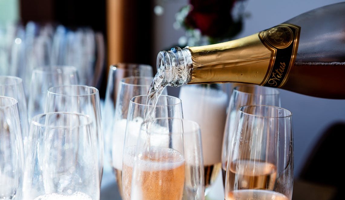 pouring champagne on a glass