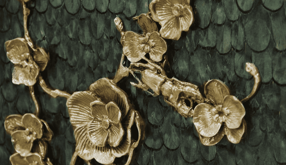 KOKET Spellbound Intoxicating Savoir-faire - Peacock colored natural feathers and handworked brass orchids applied to a luxury cabinet