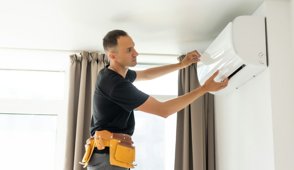 man cleaning air conditioner