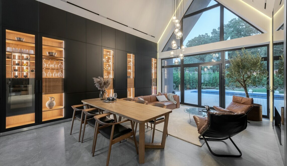 A dining room with a large wooden table