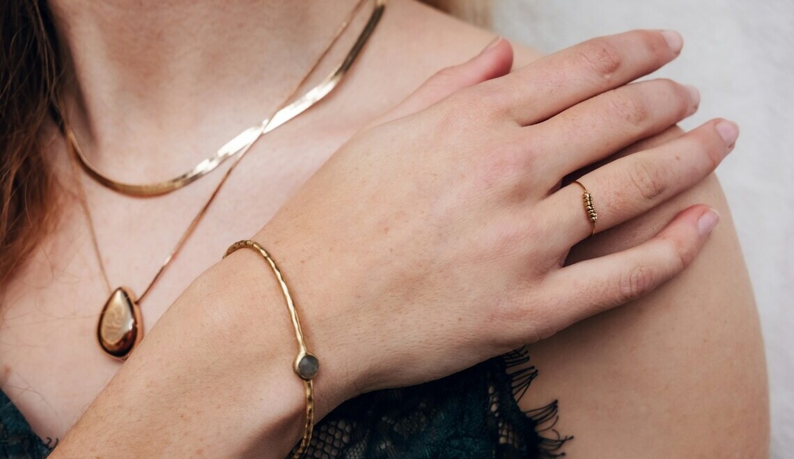 a woman wearing gold jewelry