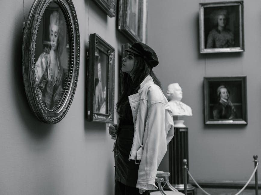 White-glove movers carefully wrapping fine art for transport during a luxury relocation