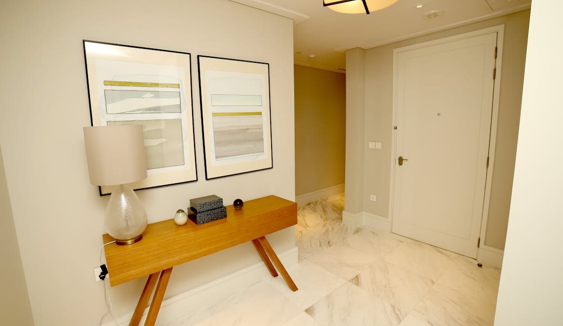 Elegant foyer with curated art pieces and designer furniture during a luxury home transition