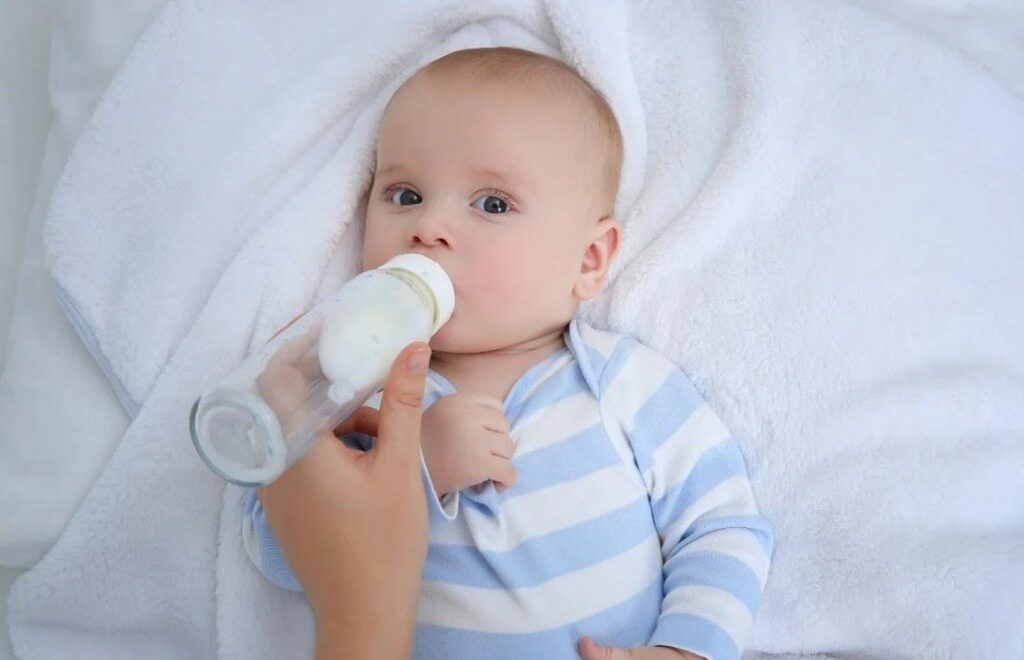 baby drinking milk from a bottle