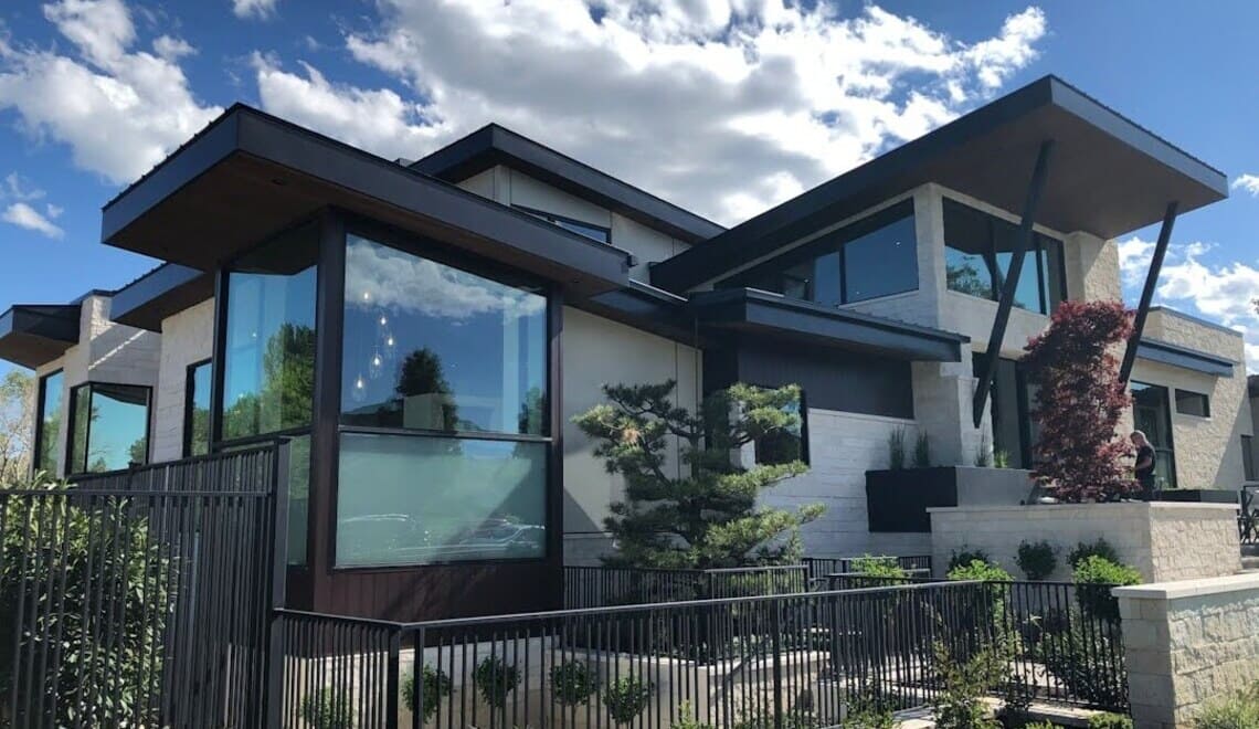 A mesh gutter guard installed along a luxury home roofline - Photo by Naomi Ellsworth on Unsplash