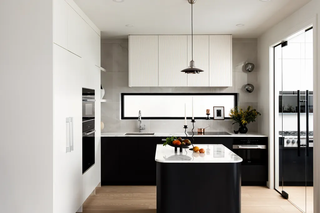 atelier fen kitchen with black island and picture window