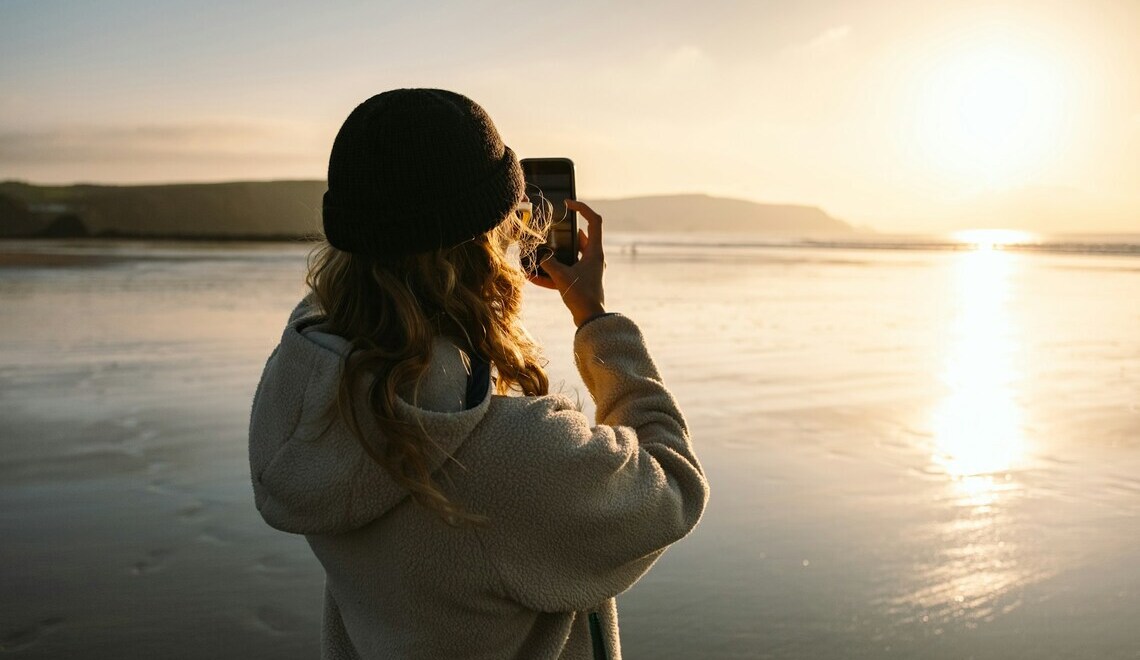 woman taking a picture with her phone