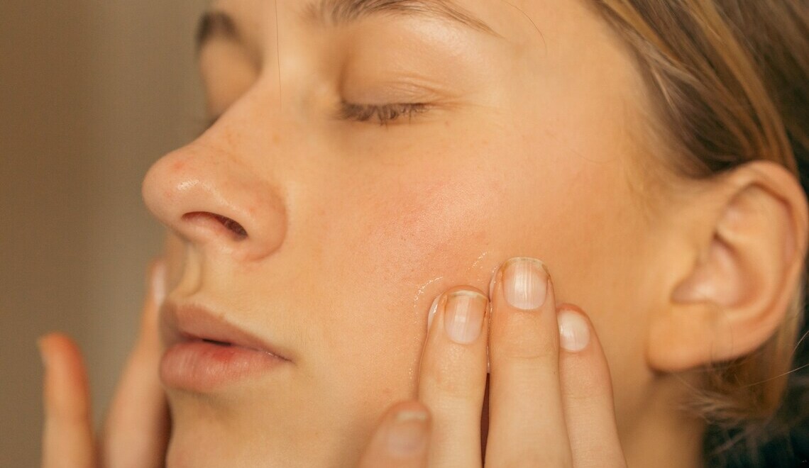 woman applying a cream on her face
