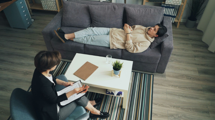 High-angle view of a patient lying on a couch during a therapy session