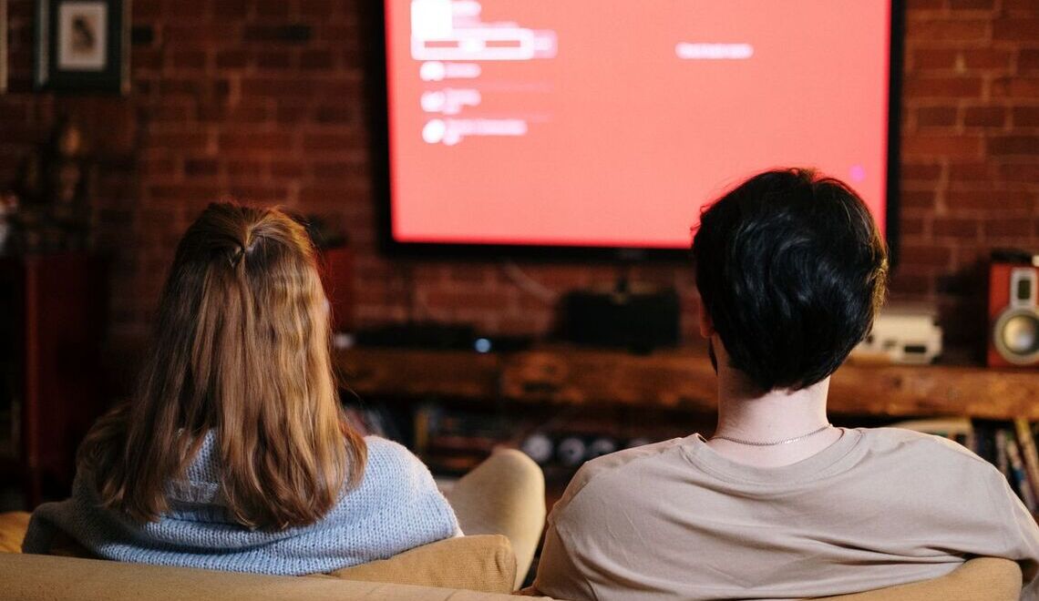 two people watching tv