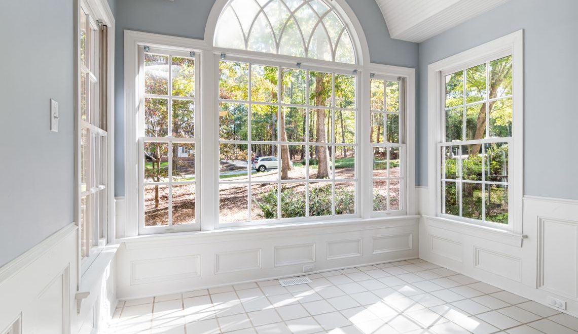 bright, empty sunroom with large windows