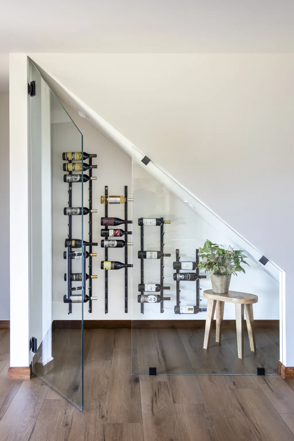 under stair glass wine display with wall mounted racks at Evergreen Ranch