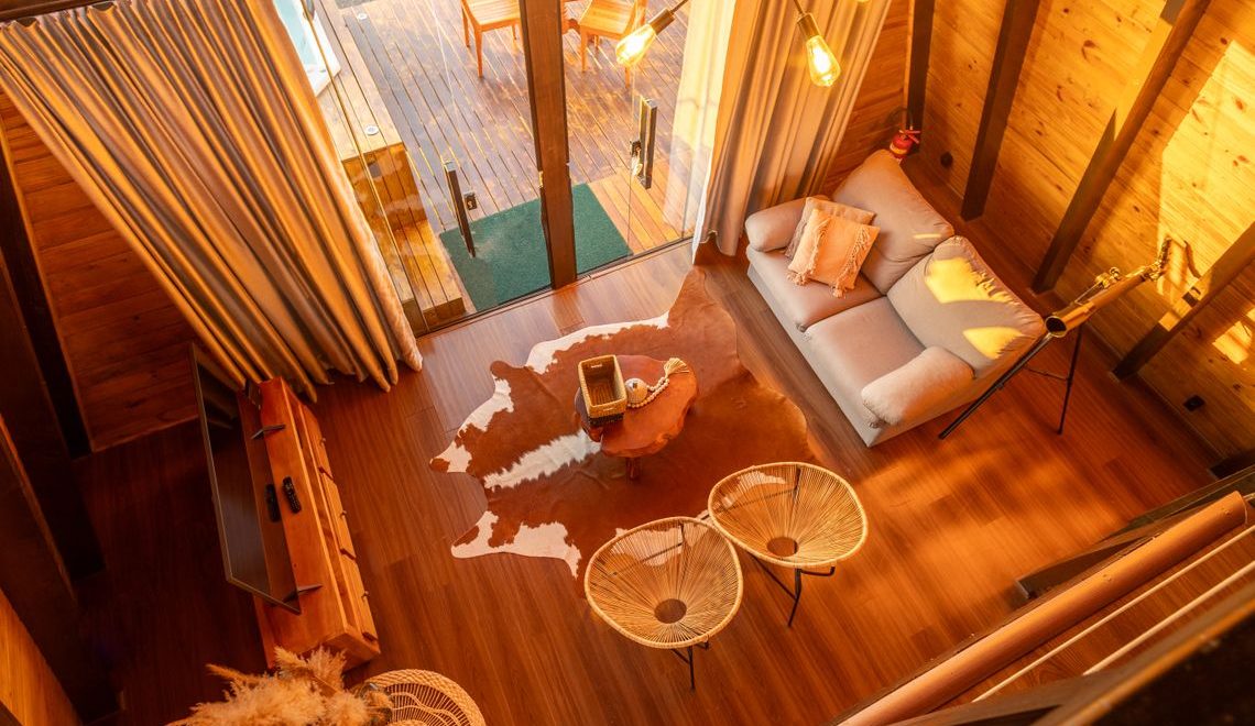 Warm-toned cottage living room with modern furniture and wooden accents.