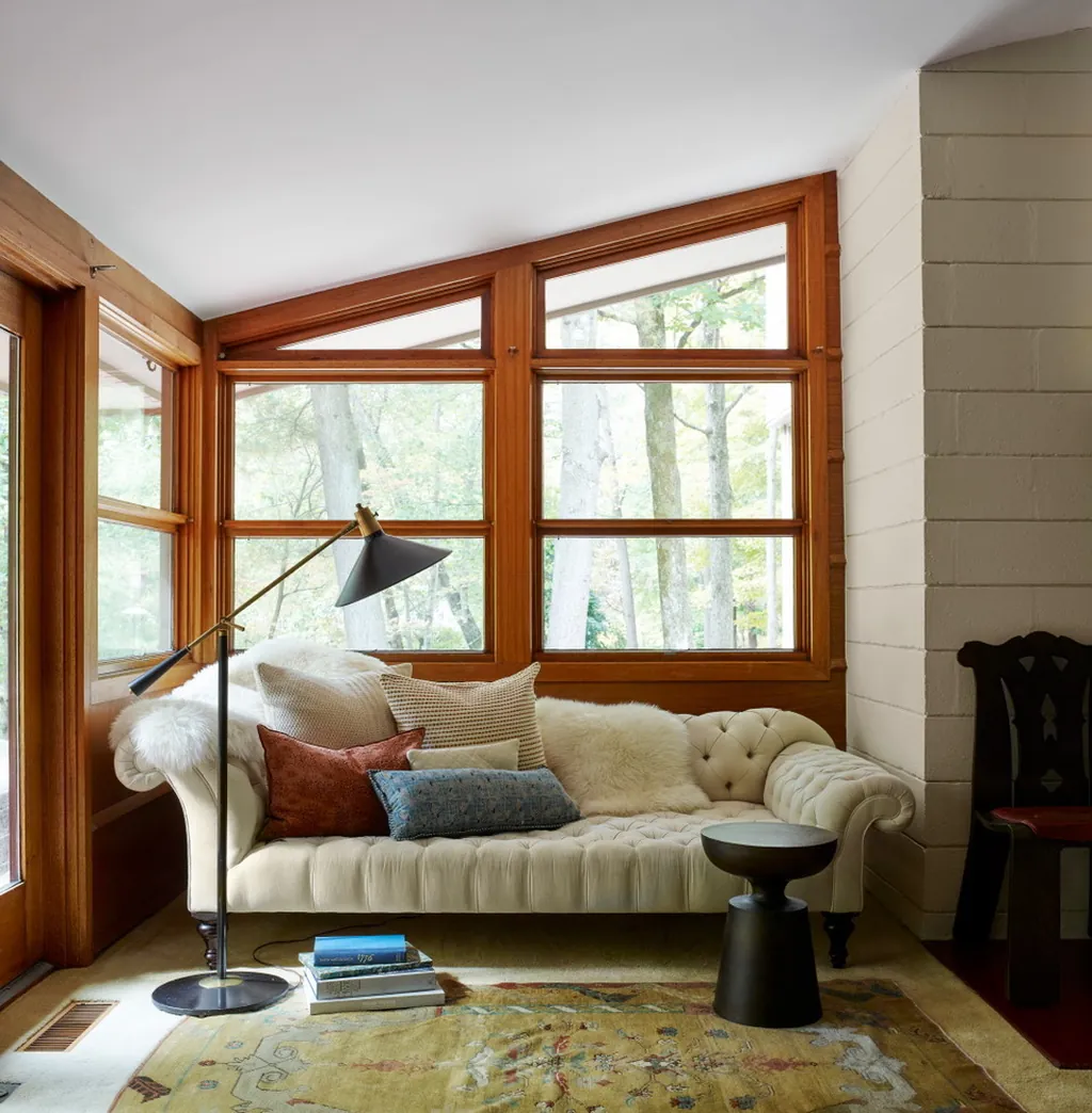 sunroom with tufted sofa and clerestory windows designed by sarah magness