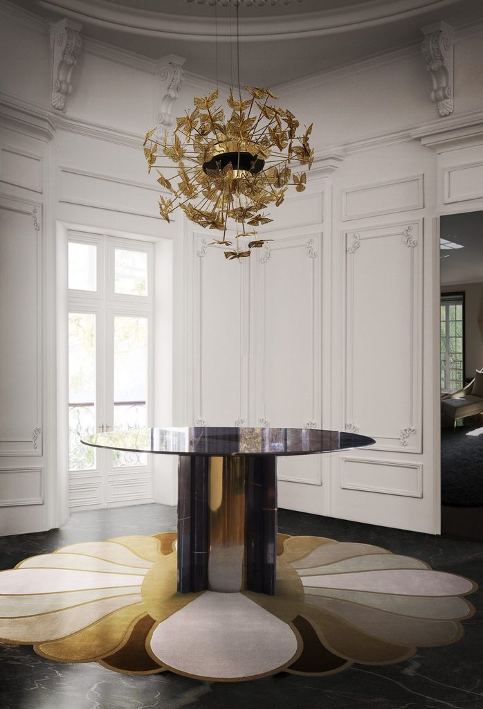 Gold butterfly chandelier above a round table in an elegant entryway